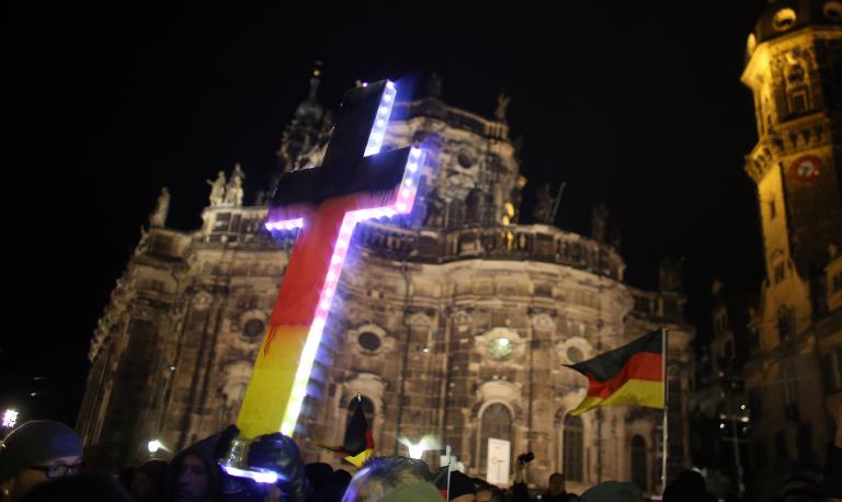 A far right protest in germany in front of a church.